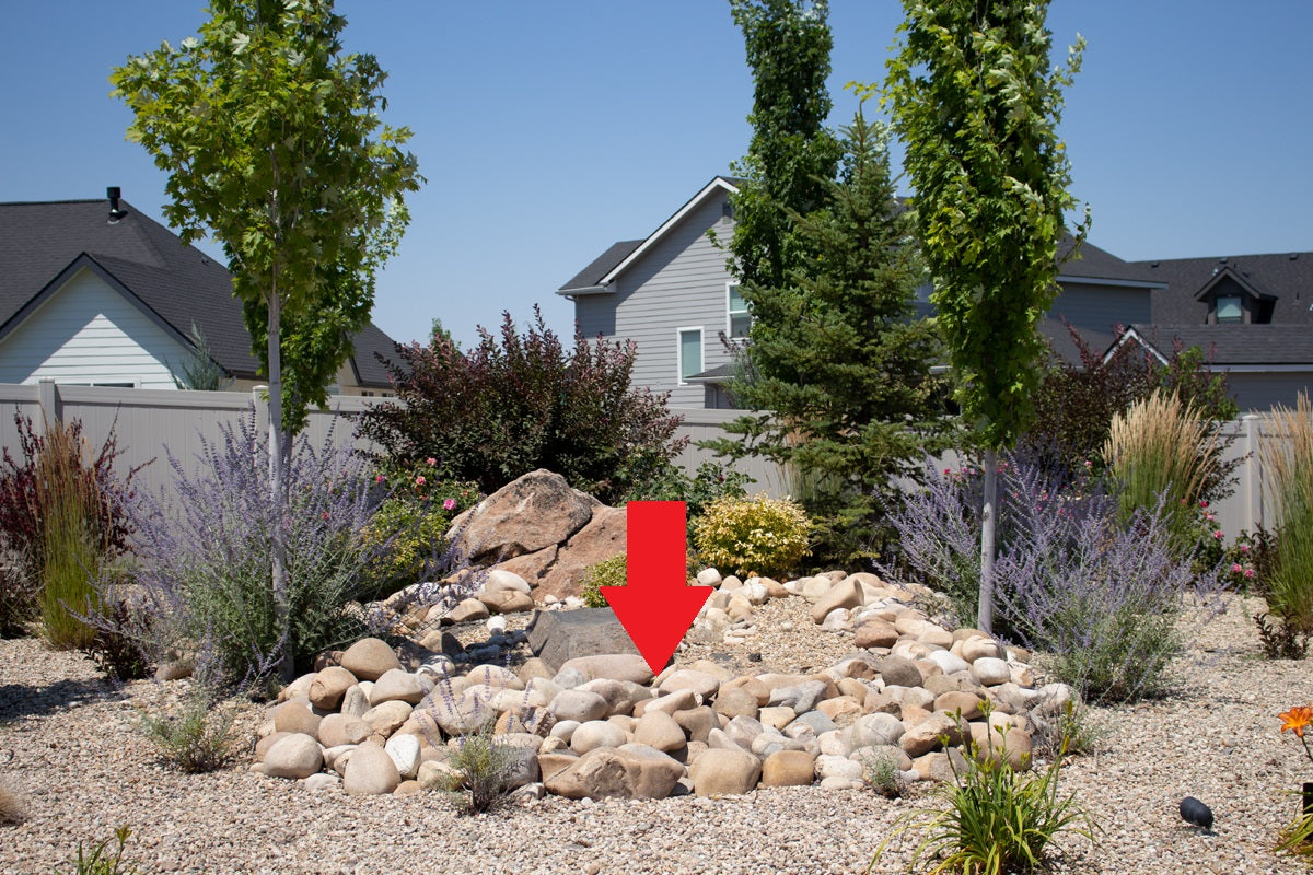 arrow pointing to a gravel rock bed